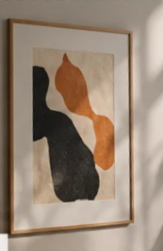 Framed abstract artwork in ochre, charcoal and cream